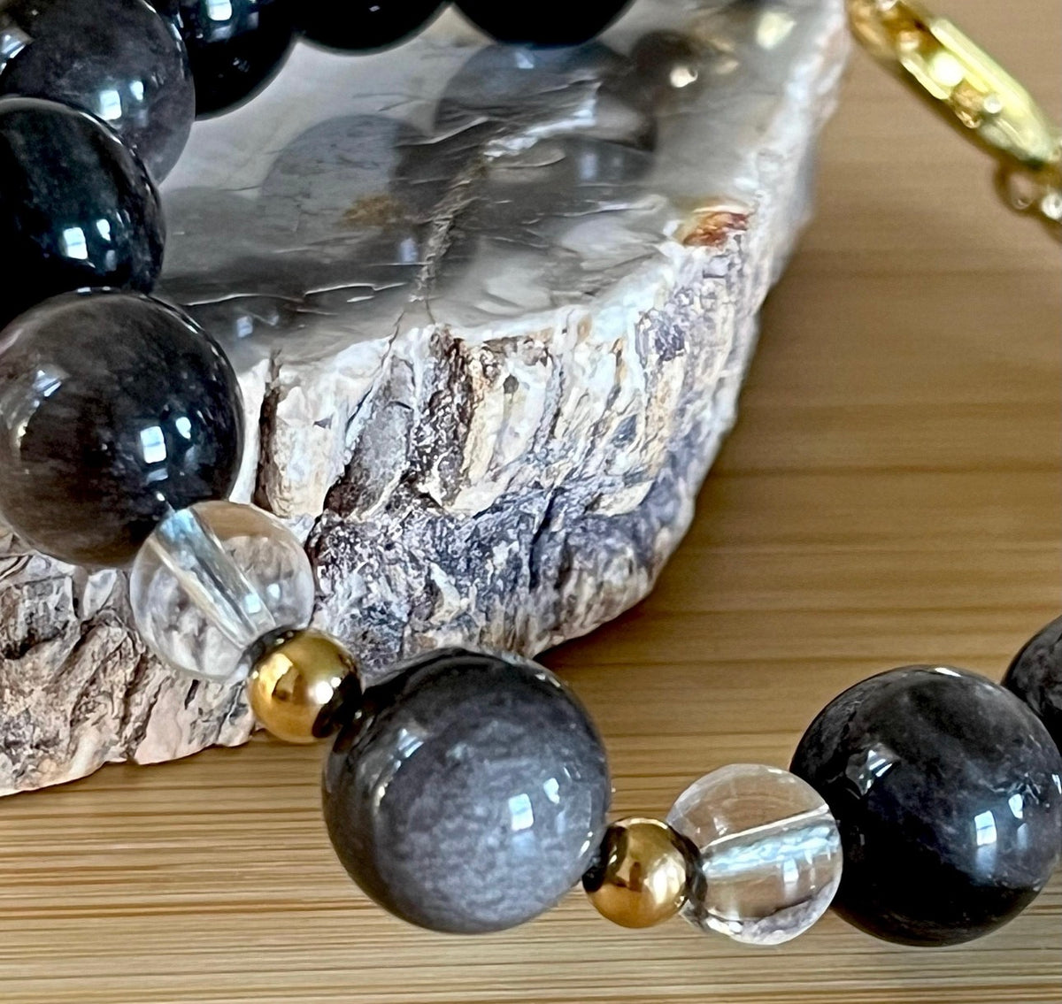 Silver sheen obsidian and clear quartz bracelet and earrings. Pair the “Silver Bells” bracelet and/or earrings with your little black party dress and be the Belle of the Ball!