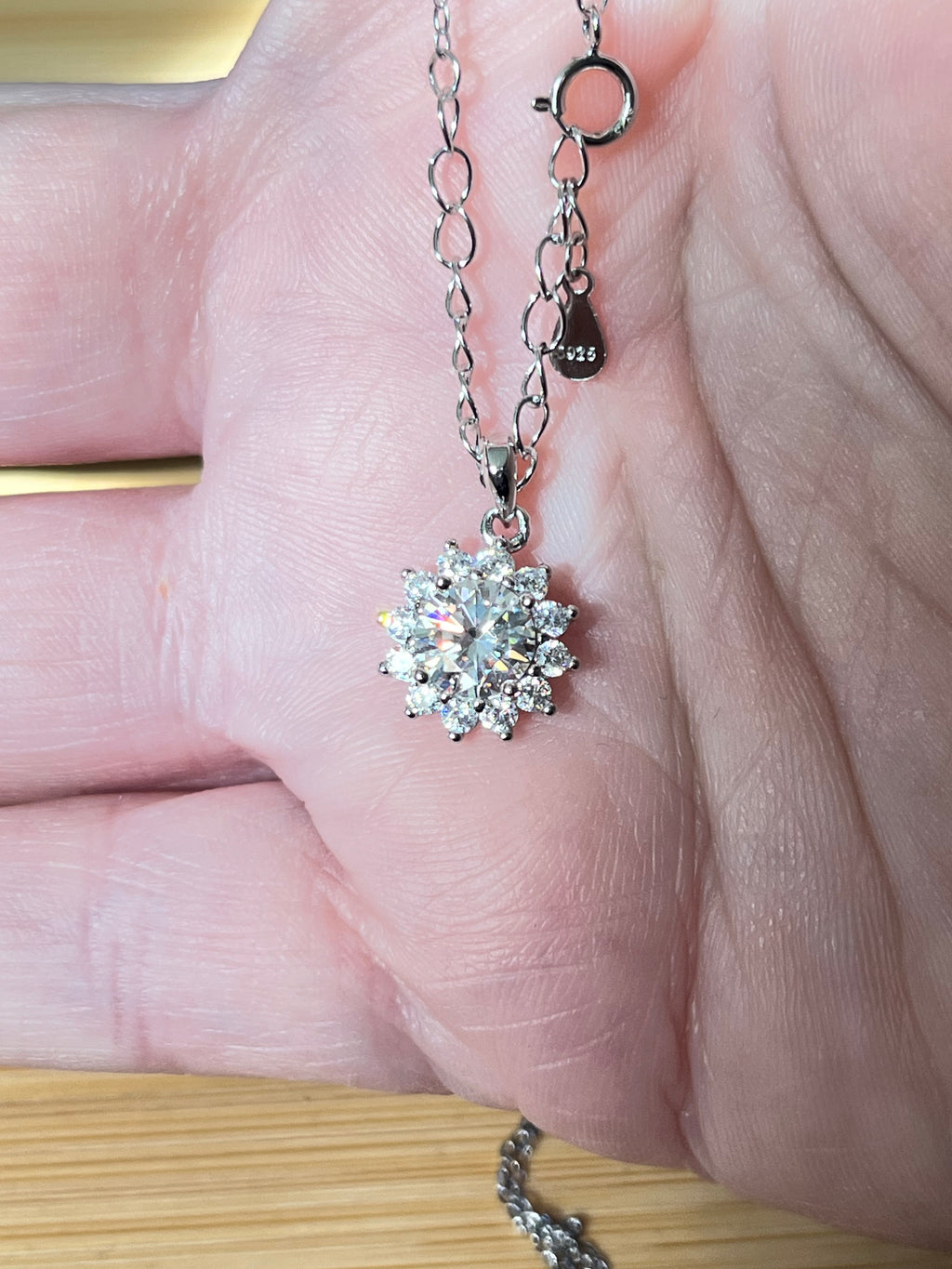 Moissanite necklace. A 1ct or 3ct Moissanite in a halo of sparkling white zircons (I call it the “Sunflower” pendant)! In sterling silver and 18k!