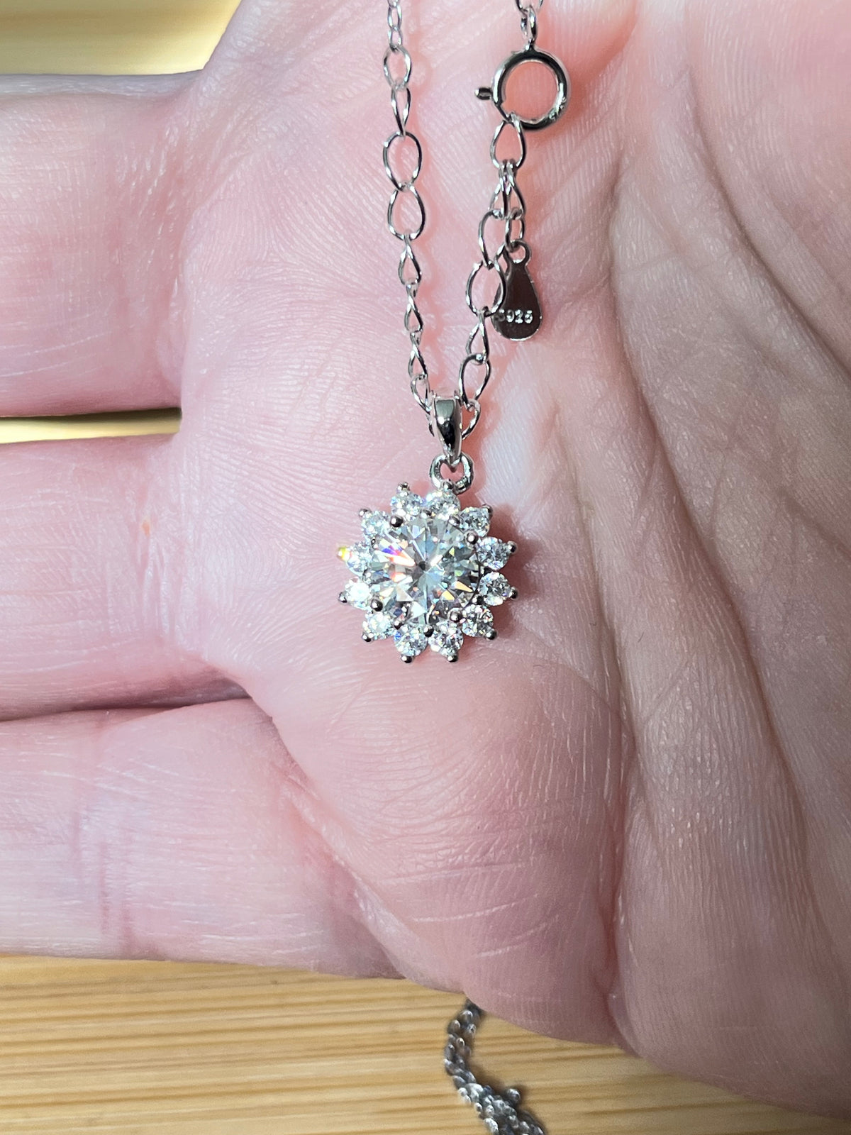 Moissanite necklace. A 1ct or 3ct Moissanite in a halo of sparkling white zircons (I call it the “Sunflower” pendant)! In sterling silver and 18k!