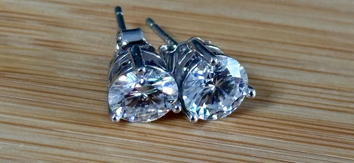 Moissanite earrings. A delicate certified 2cttw pair of 3-prong or 4-prong round brilliant Moissanites in 18k gold-embraced sterling silver baskets! Classic!