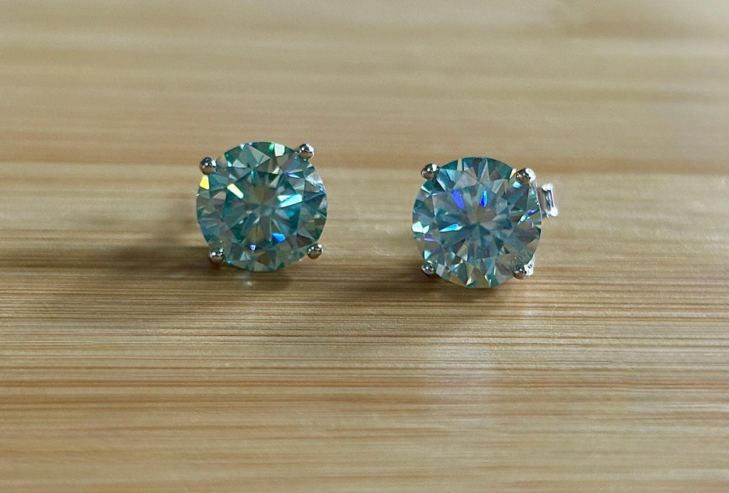 Moissanite earrings. A 6ctw certified pair of true icy baby blue Moissanite studs in sterling silver baskets with gleaming white rhodium!