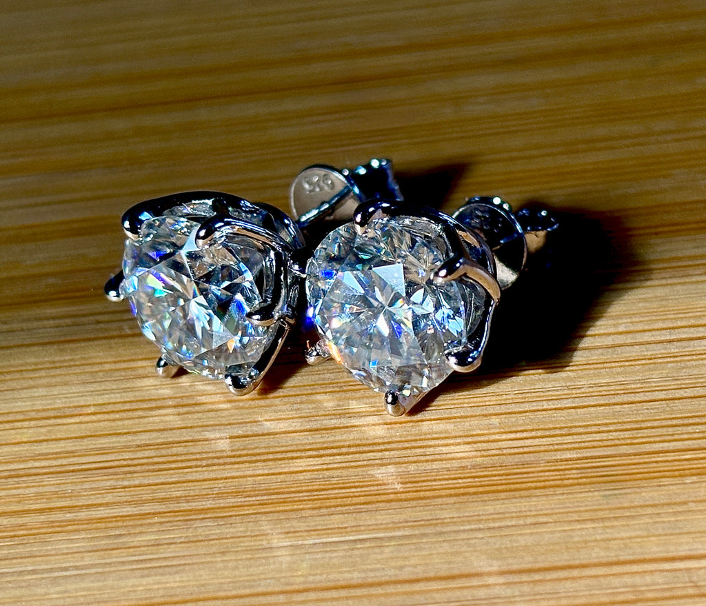 A 10ctw pair of double certified Moissanite studs in lotus-shaped sterling silver baskets!