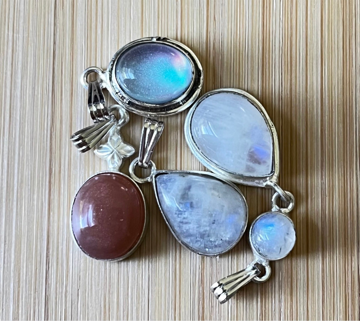 Moonstone, peach moonstone and lab “aurora” opal pendants in sterling silver!