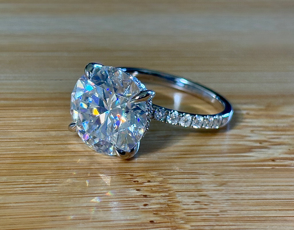 Moissanite solitaire. A glorious 10ct 8H8A Moissanite in a 4-prong mounting with a Moissanite “hidden halo” and shoulders, an 11.3cttw ring!