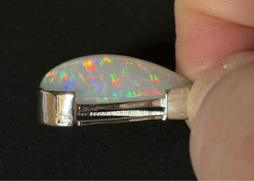 A GORGEOUS 11.05ct AAA+ grade Ethiopian pendant, an elongated pear-shaped cabochon with galaxy pattern fire and phenomenal play of color!