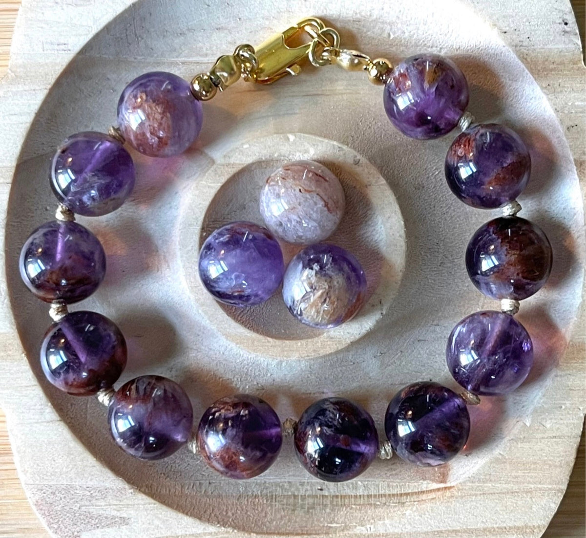 Super seven amethyst bracelet. AAA-grade 12mm “super seven”, mineral name cacoxenite amethyst, hand-knotted with silvery or golden hardware!