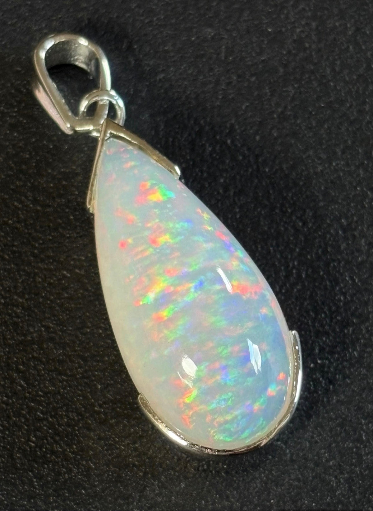 A GORGEOUS 11.05ct AAA+ grade Ethiopian pendant, an elongated pear-shaped cabochon with galaxy pattern fire and phenomenal play of color!