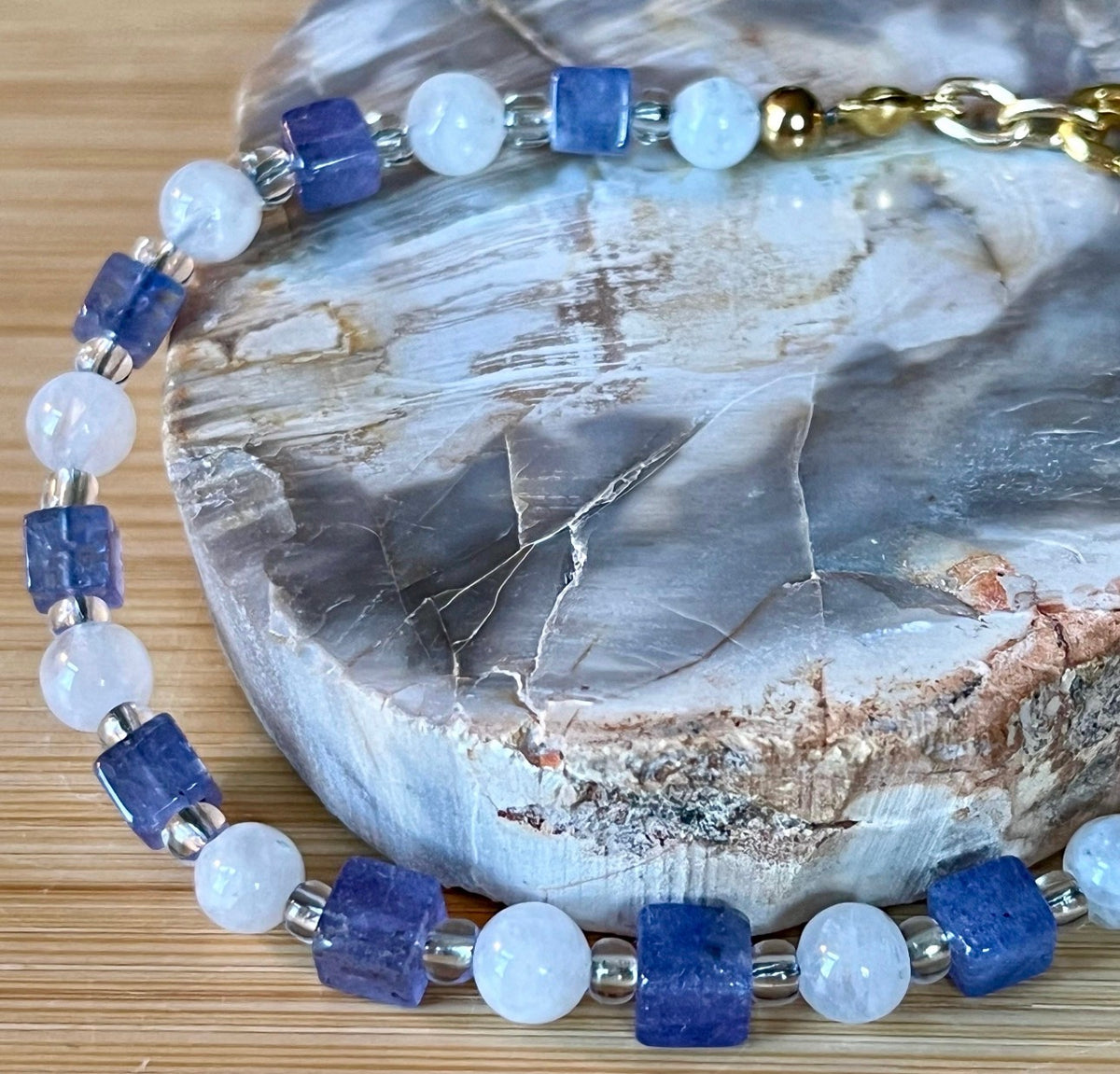 Moonstone and tanzanite bracelet. Dusky tanzanite cubes and round moonstones on stainless steel jeweler’s wire! Pretty and petite!