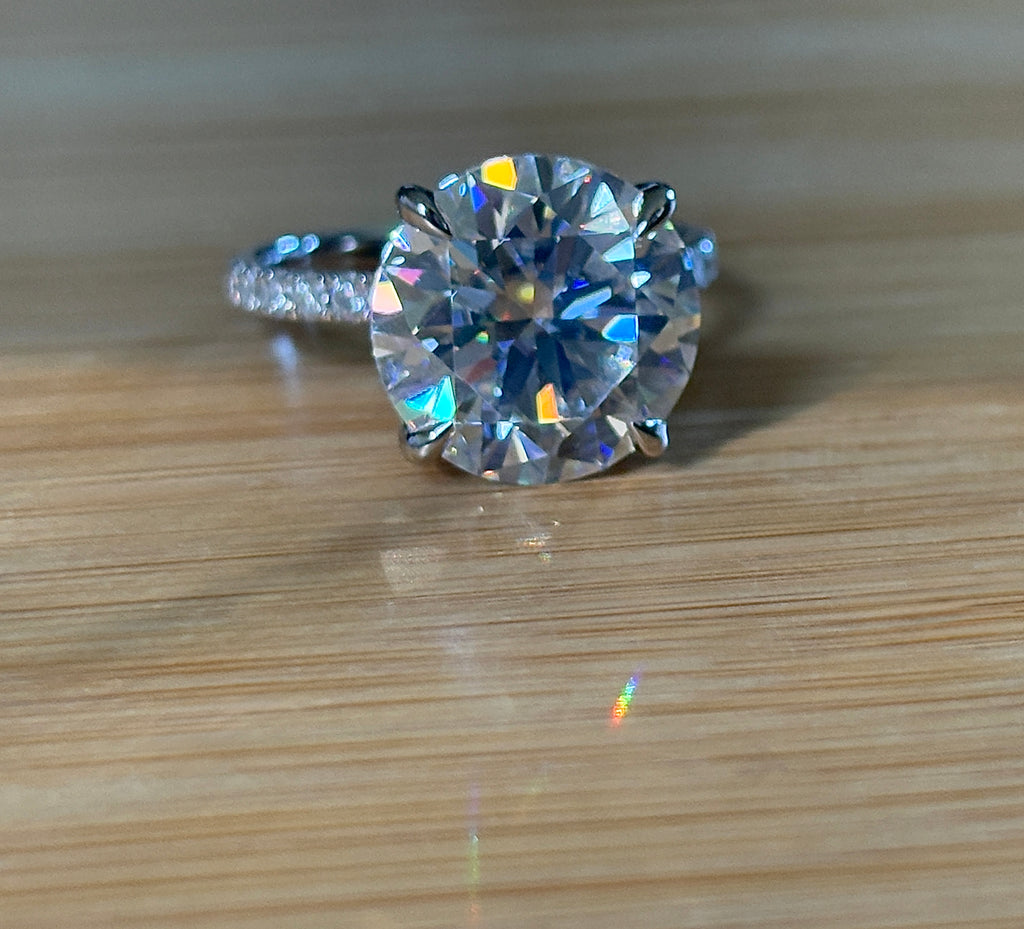 Moissanite solitaire. A glorious 10ct 8H8A Moissanite in a 4-prong mounting with a Moissanite “hidden halo” and shoulders, an 11.3cttw ring!