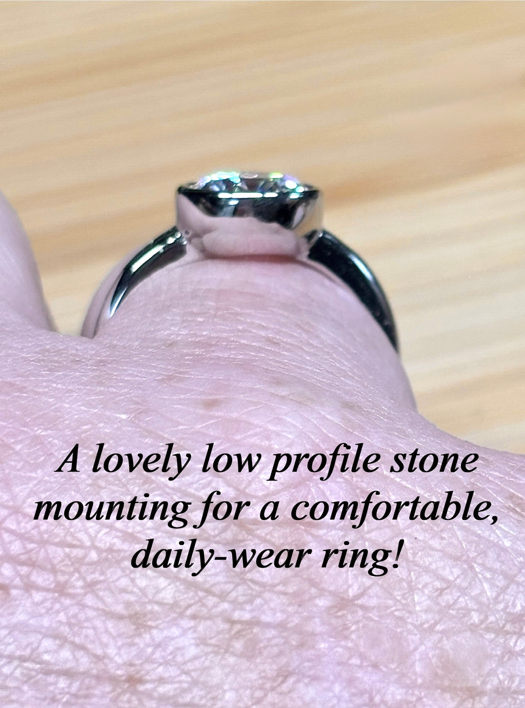Moissanite solitaire. A 3ct certified round brilliant Moissanite in a weighty solid sterling silver bezel mounting with Seiko-electroplated 18k! A sleek, minimalist design!