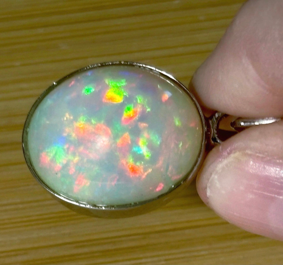 A 17.28ct AAA grade Ethiopian opal pendant with multi-patterned fire and beautiful play of color, hand-picked by Hand Knotted Jewelry!