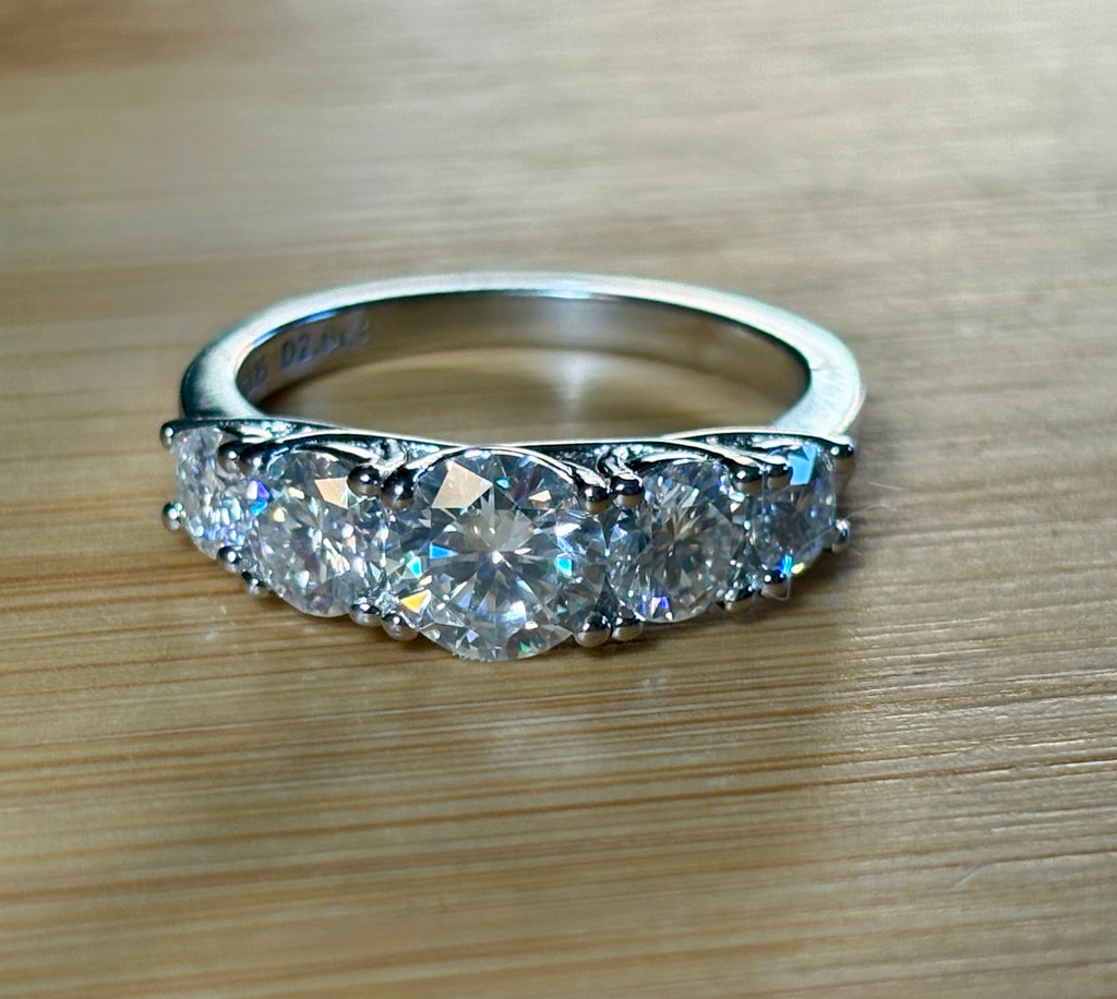 Moissanite ring. A 2.5ctw certified Moissanite ring, for those who want plenty of sparkle but a daintier ring! This feminine 5-stone design is just the thing!