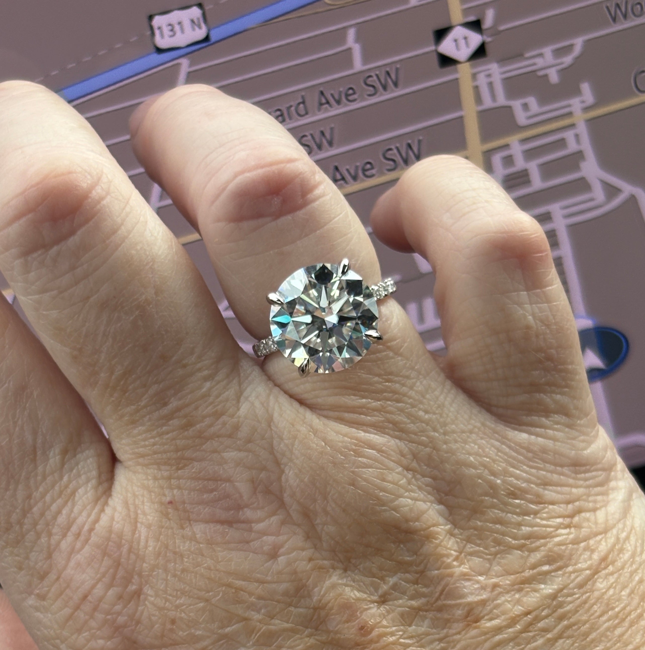 Moissanite solitaire. A glorious 10ct 8H8A Moissanite in a 4-prong mounting with a Moissanite “hidden halo” and shoulders, an 11.3cttw ring!