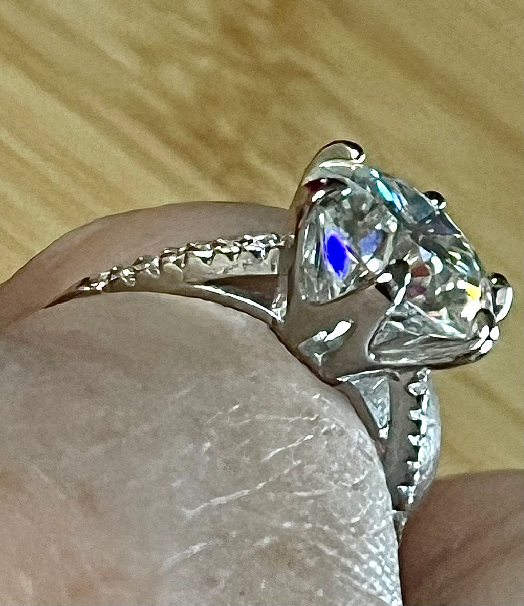 Moissanite ring. A certified 5ct Moissanite solitaire with zircon-accented shoulders, set in sterling silver and bathed in 18k!