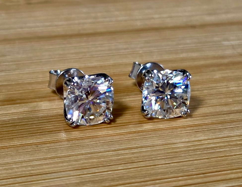 6ctw cushion-cut Moissanite studs in elegant sterling silver double-claw mountings! With brilliant faceting, these earrings are showstoppers!
