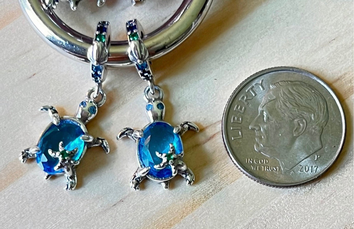 Paw print charms, dog lover charms, dog bone charms, turtle charm and cross charm! All solid sterling silver charms!