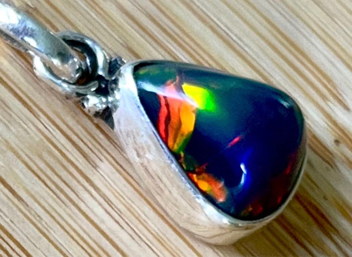 2.99ct Ethiopian opal pendant. AAA grade smoked opal cabochon pear in solid sterling silver. This flashy stone measures 9.6mm x 13mm!