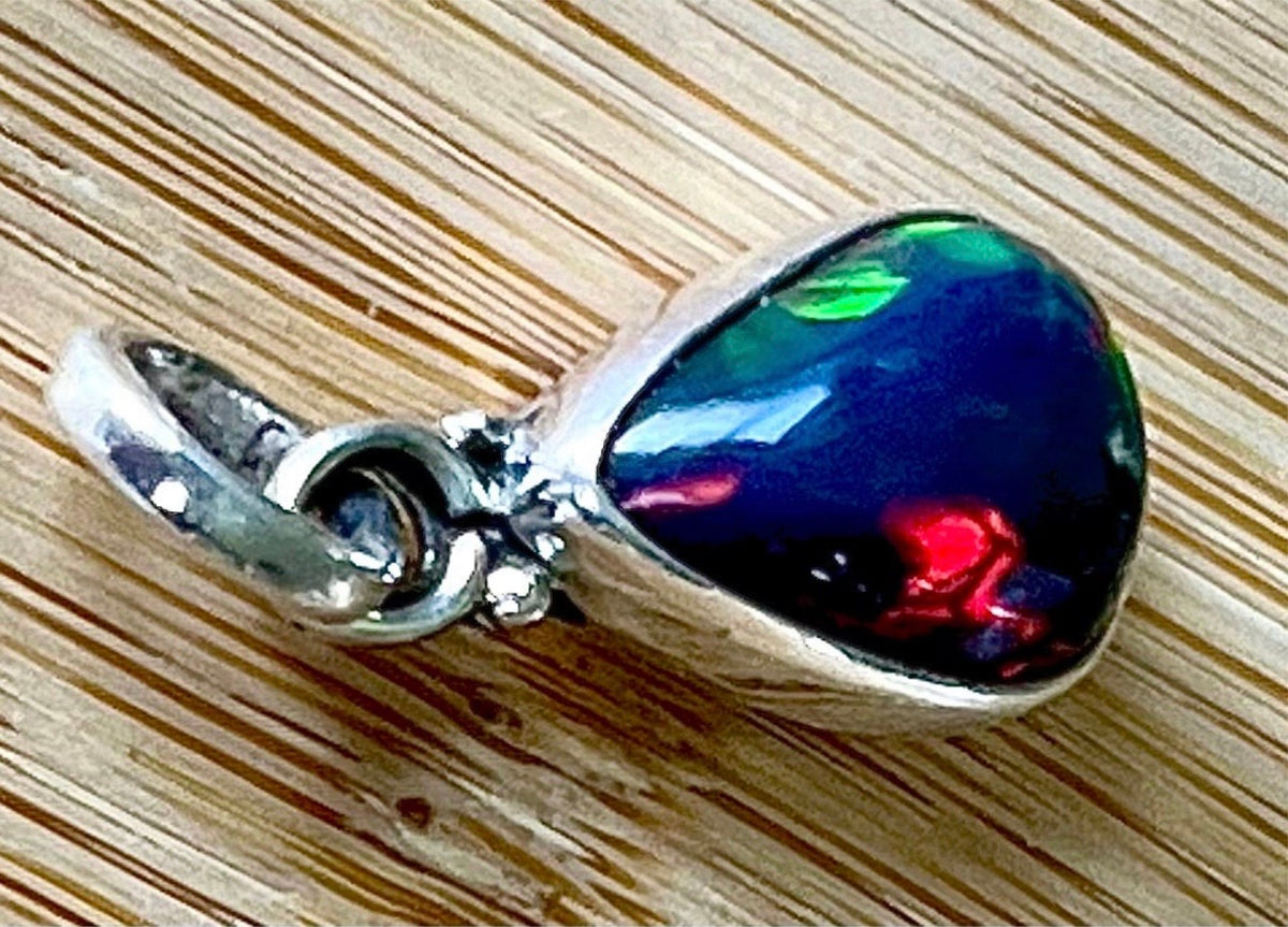 2.99ct Ethiopian opal pendant. AAA grade smoked opal cabochon pear in solid sterling silver. This flashy stone measures 9.6mm x 13mm!