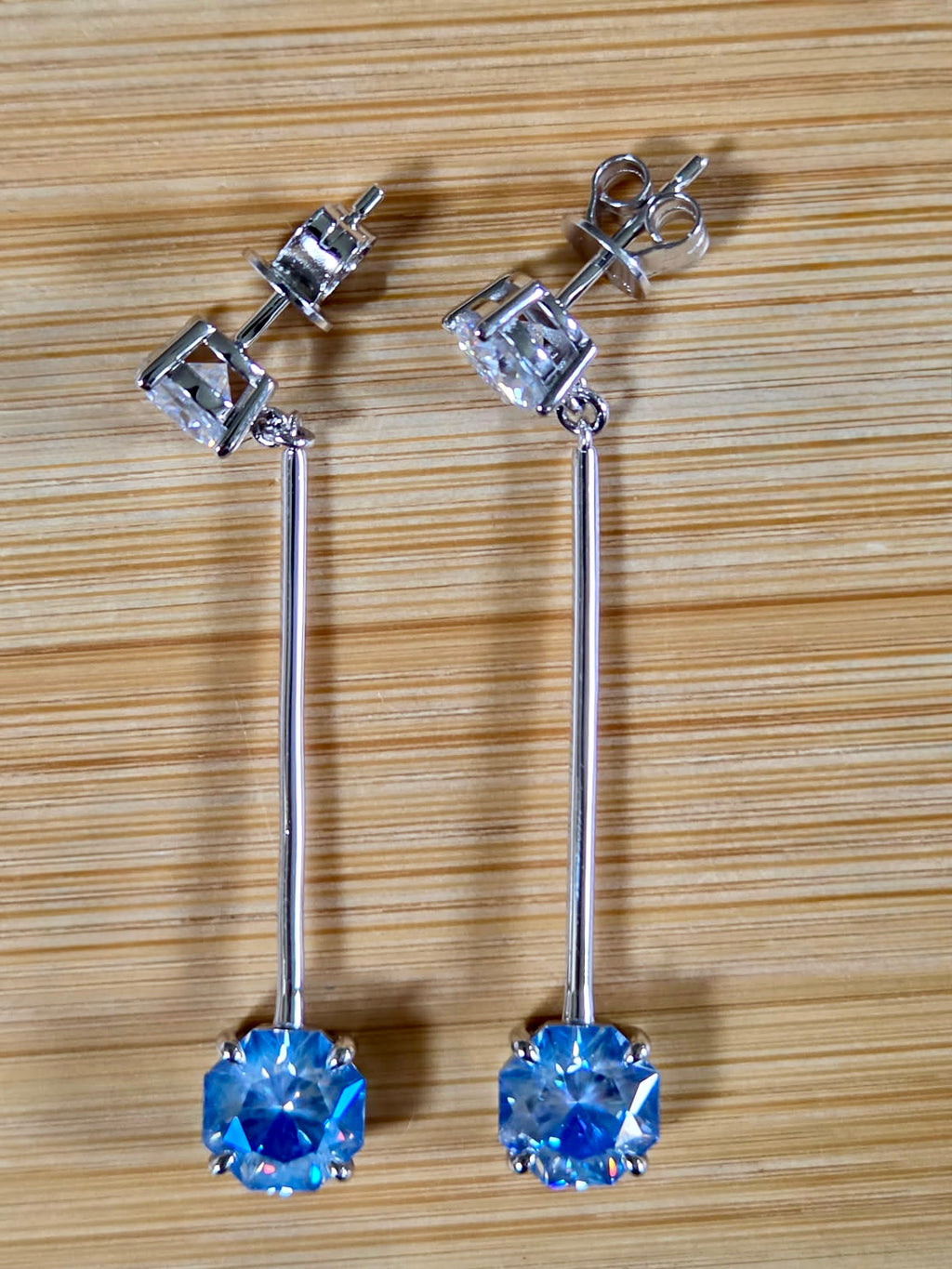 8ctw Moissanite pendulum earrings, with 3ct octagonal frosty aquamarine Moissanites at the bottom of the pendulum, and 1ct white round brilliant Moissanites at the top! Full Argentium silver construction with sterling silver disk backs! An HKJ exclusive!