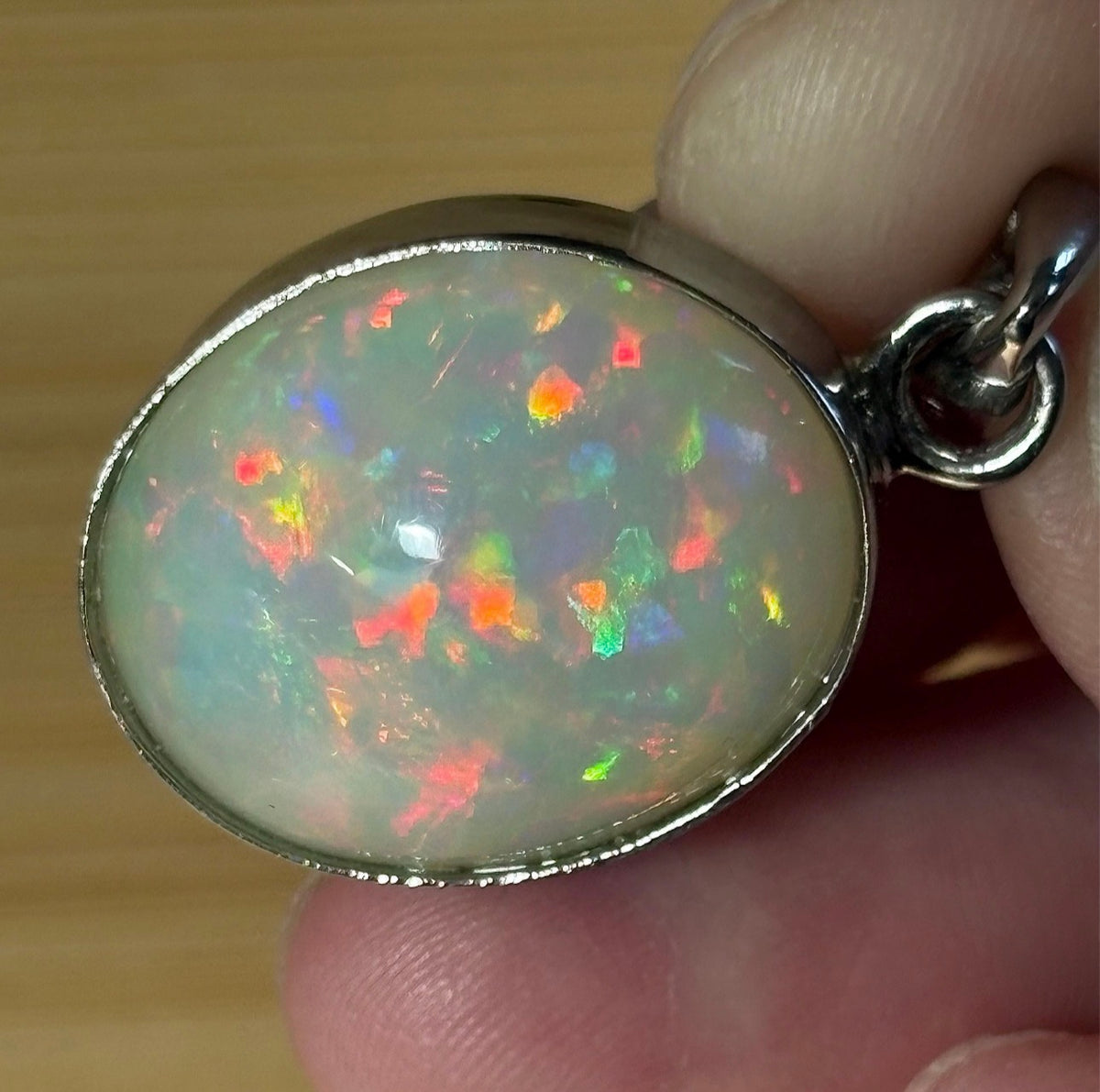 A 17.28ct AAA grade Ethiopian opal pendant with multi-patterned fire and beautiful play of color, hand-picked by Hand Knotted Jewelry!