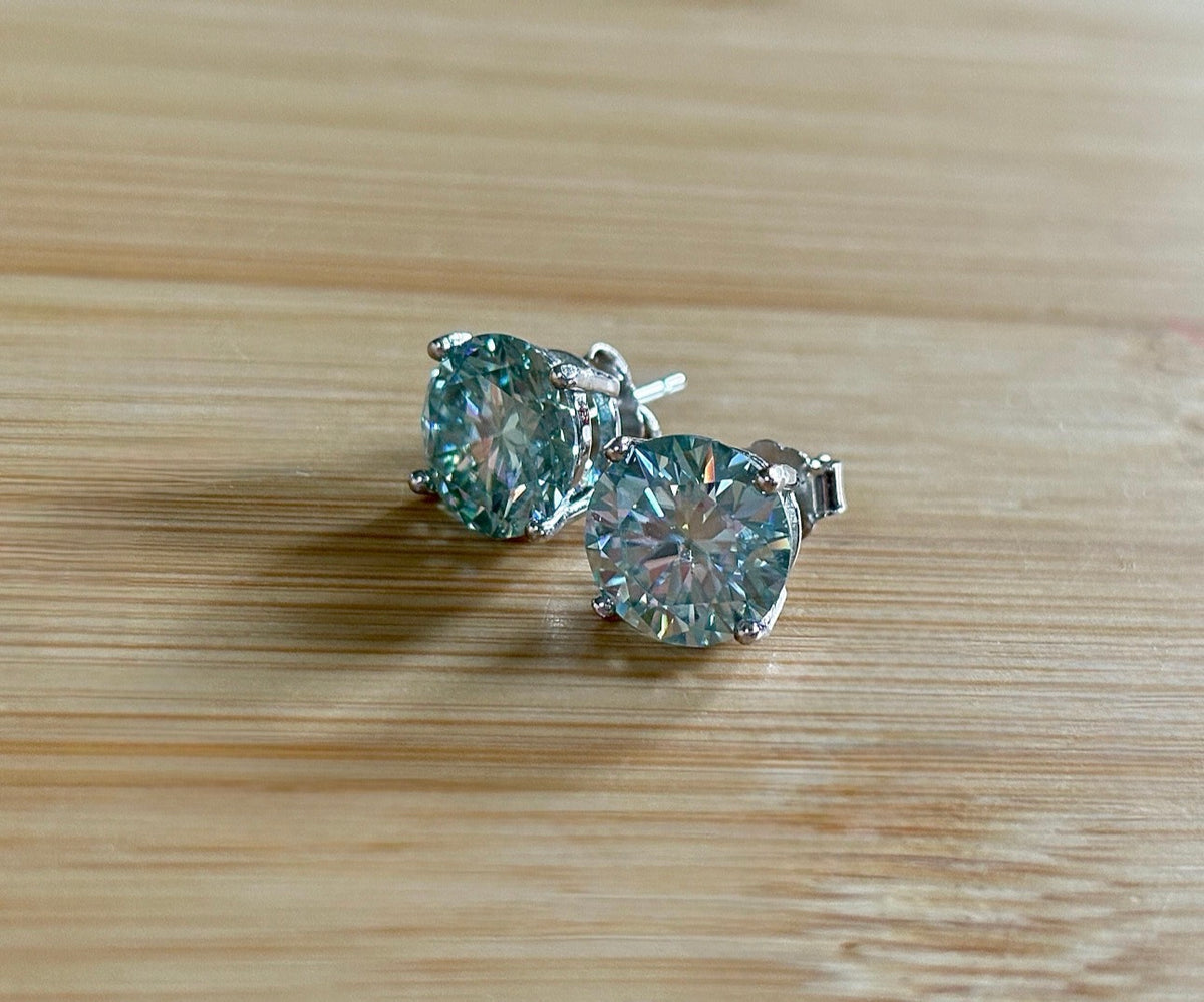 Moissanite earrings. A 6ctw certified pair of true icy baby blue Moissanite studs in sterling silver baskets with gleaming white rhodium!