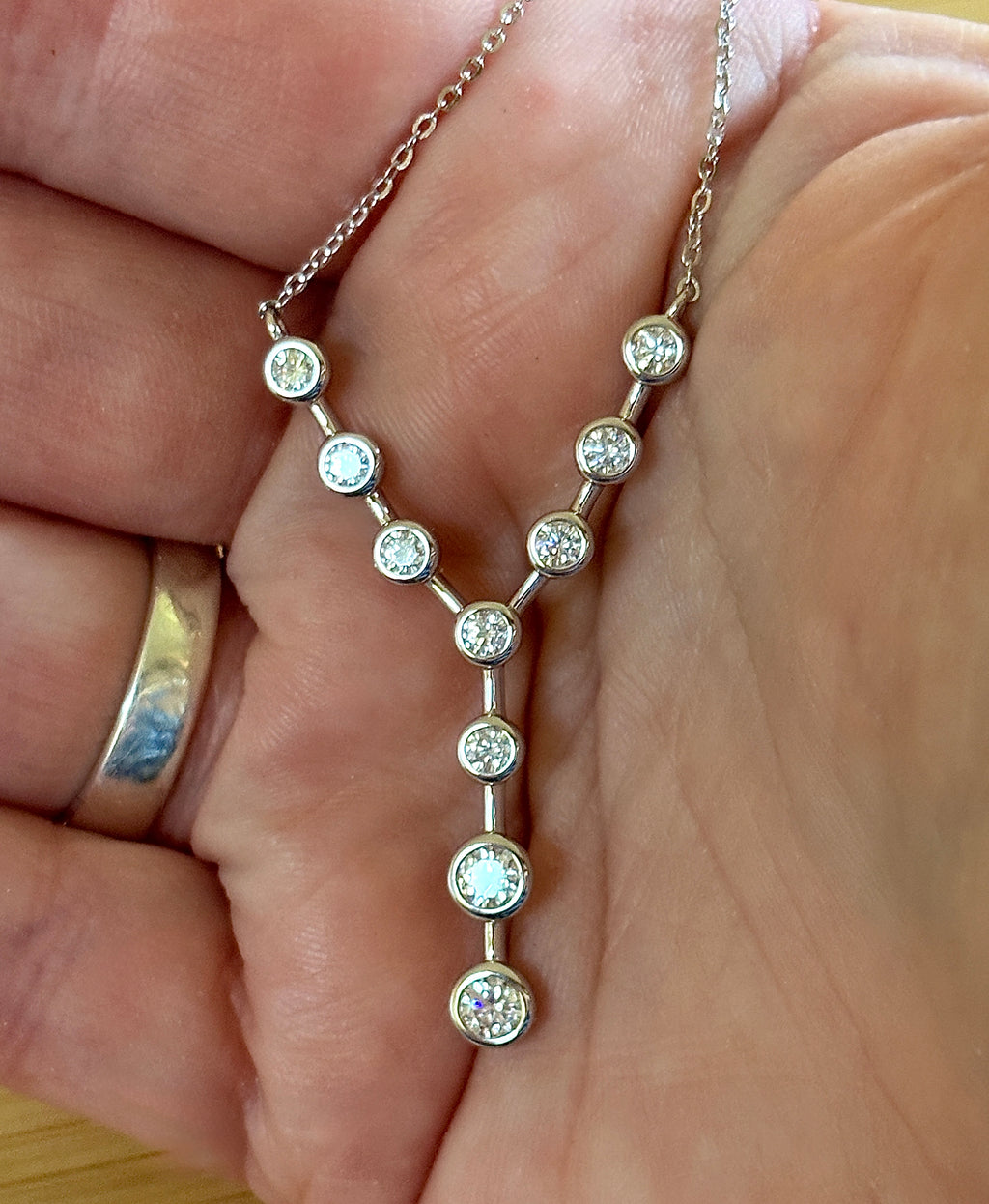 Moissanite neckpiece. A beautiful certified 1.4cttw Moissanite necklace featuring 10 round brilliants in a solid sterling bezel setting!