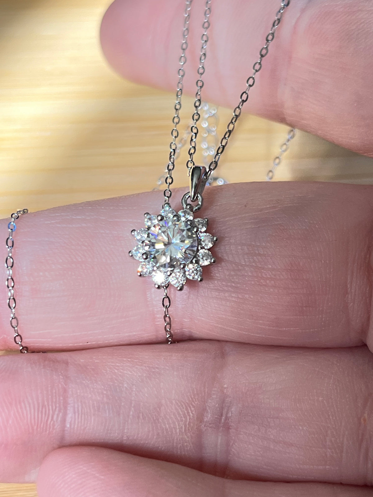 Moissanite necklace. A 1ct or 3ct Moissanite in a halo of sparkling white zircons (I call it the “Sunflower” pendant)! In sterling silver and 18k!