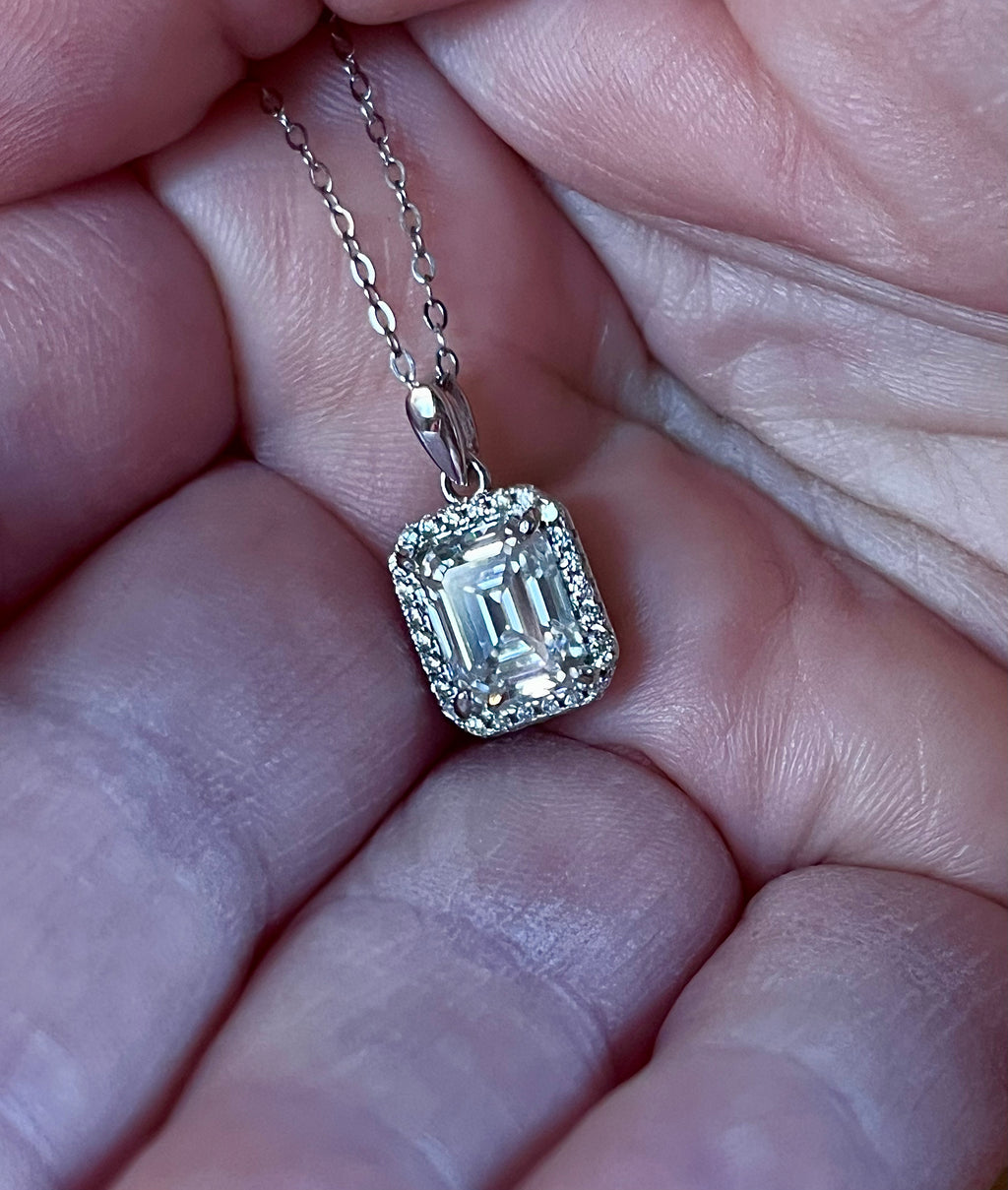 Moissanite necklace. An elegant 3ct certified emerald-cut Moissanite within a halo of shining white zircons, in 18k gold-embraced sterling!