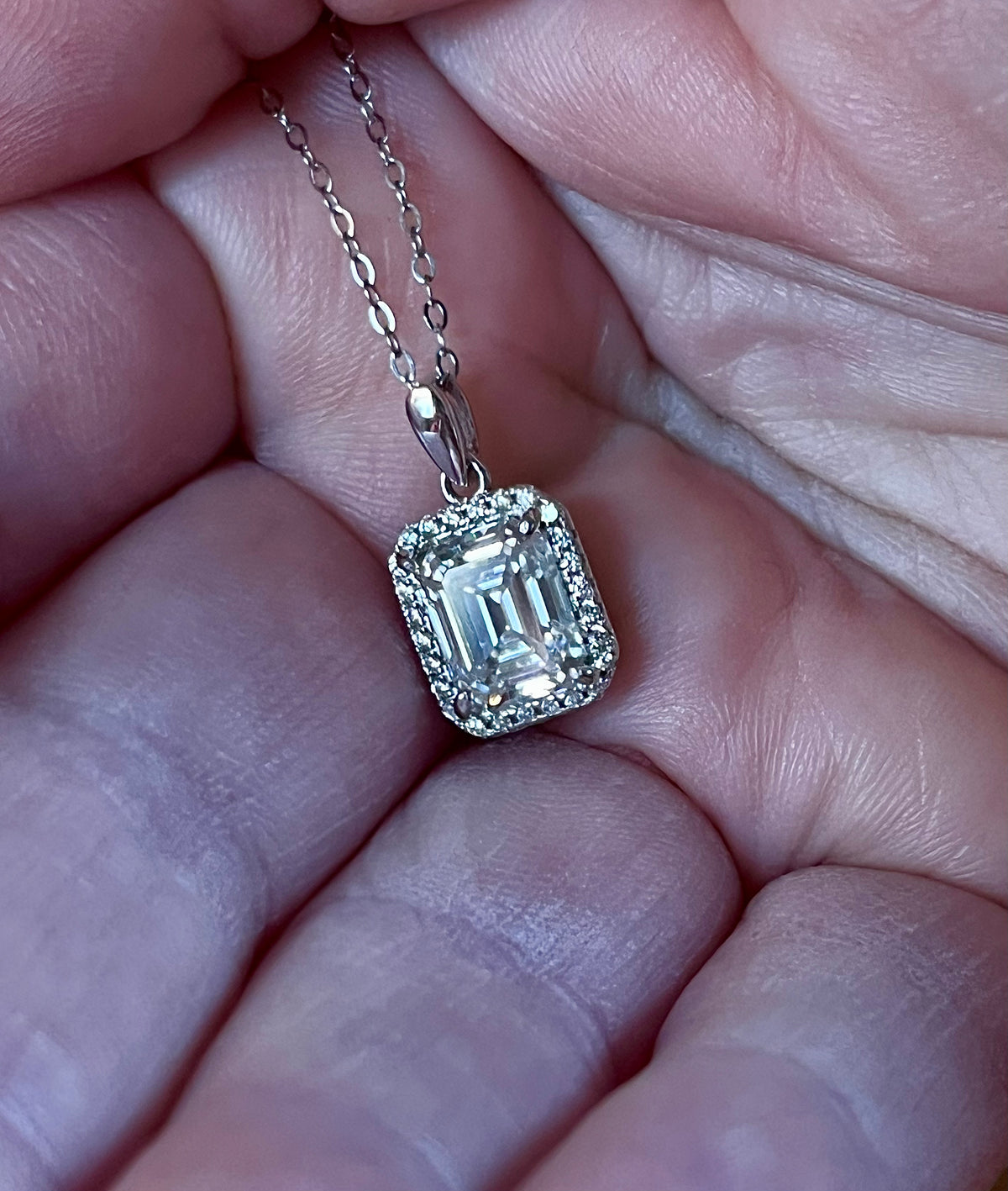 Moissanite necklace. An elegant 3ct certified emerald-cut Moissanite within a halo of shining white zircons, in 18k gold-embraced sterling!