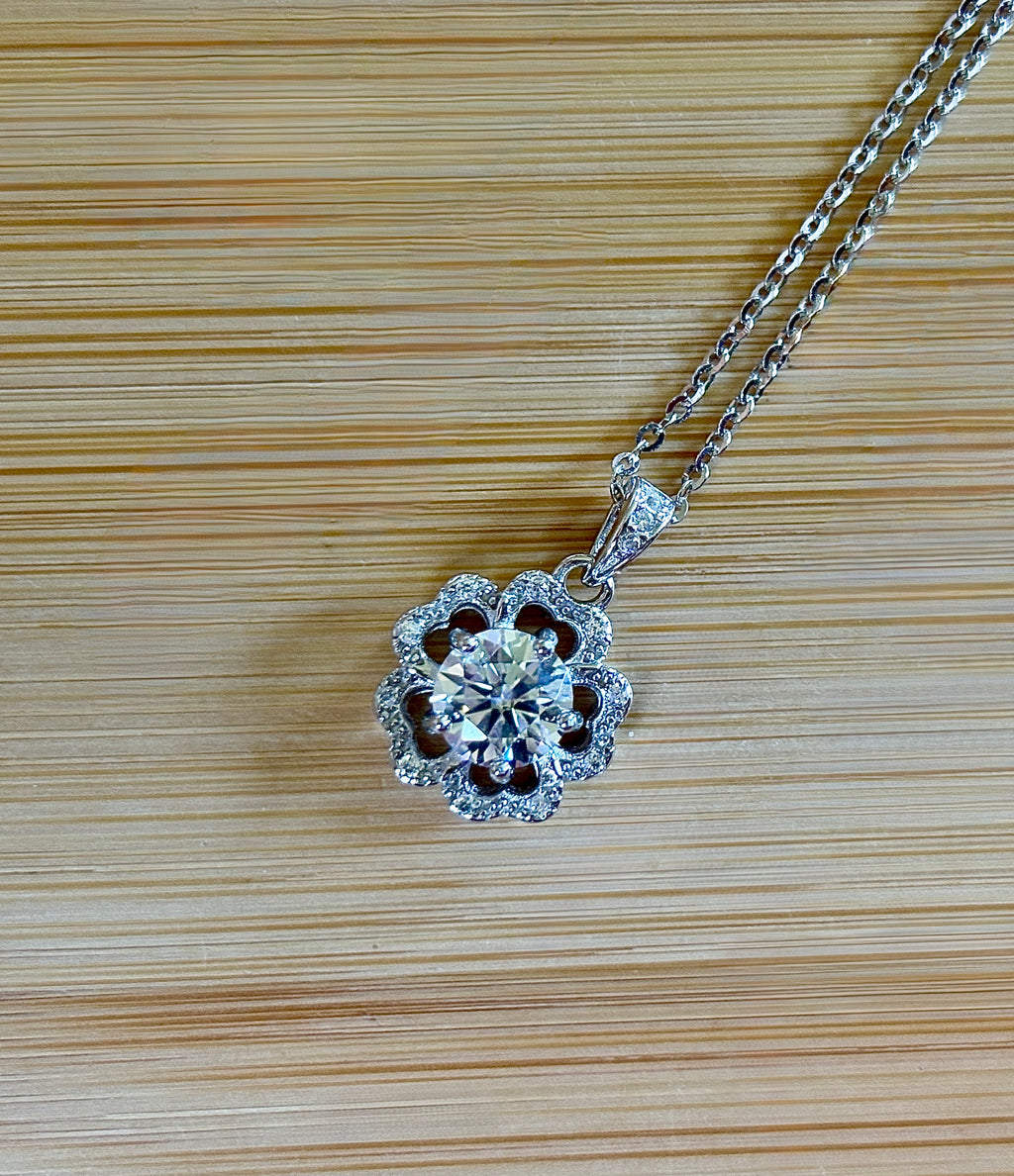 Moissanite necklace. A certified 1ct Moissanite hibiscus necklace with white zircon accents in solid sterling and white rhodium!