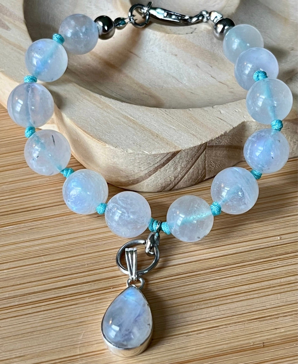 Rainbow moonstone bracelet, hand knotted with high quality 9-10mm beads! The solid sterling silver moonstone pendant is *optional*.