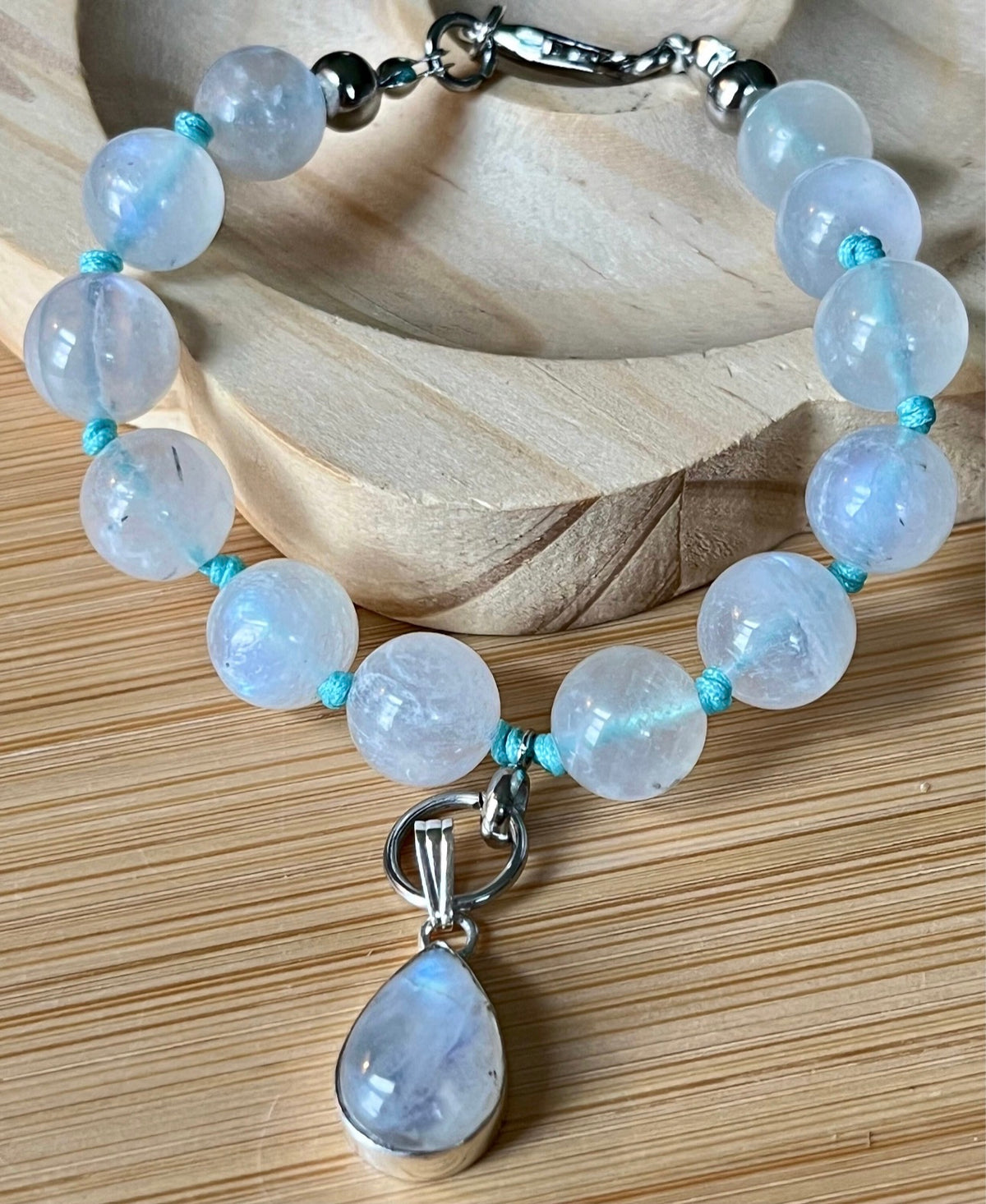 Rainbow moonstone bracelet, hand knotted with high quality 9-10mm beads! The solid sterling silver moonstone pendant is *optional*.