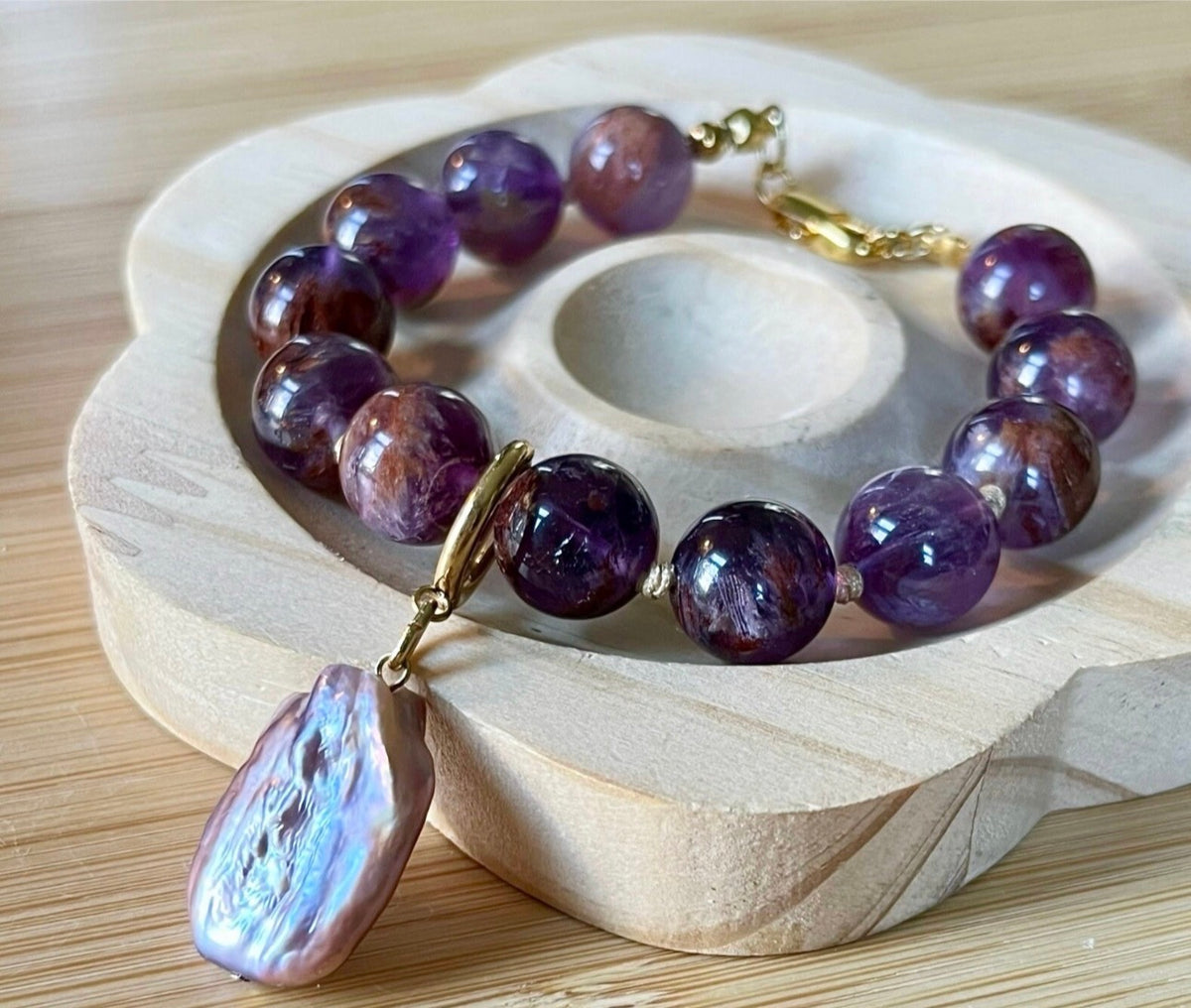 Super seven amethyst bracelet. AAA-grade 12mm “super seven”, mineral name cacoxenite amethyst, hand-knotted with silvery or golden hardware!