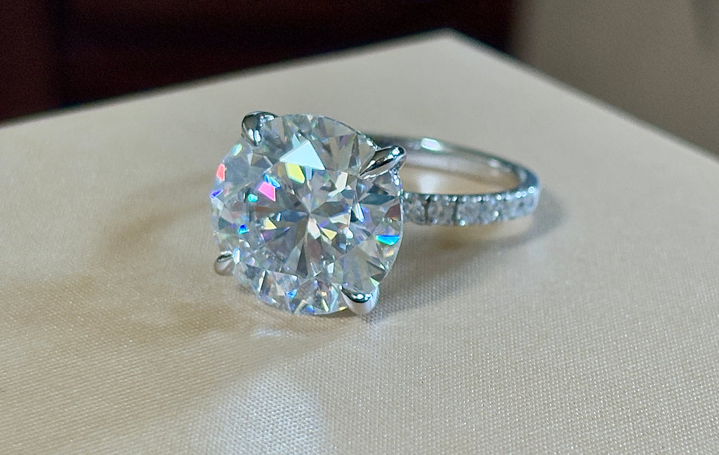 Moissanite solitaire. A glorious 10ct 8H8A Moissanite in a 4-prong mounting with a Moissanite “hidden halo” and shoulders, an 11.3cttw ring!