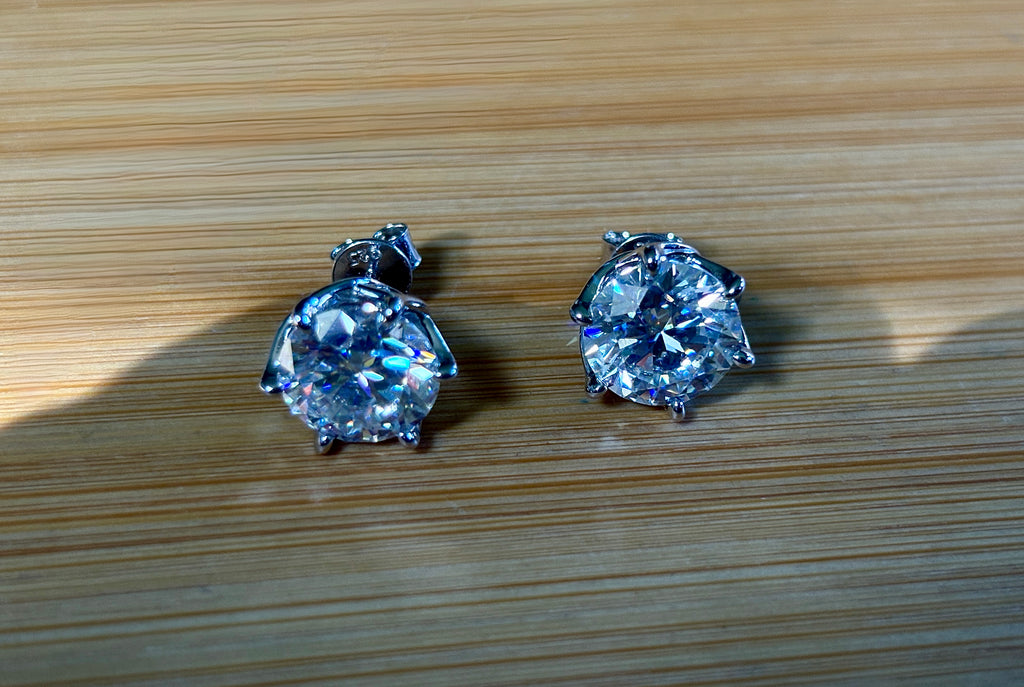 A 10ctw pair of double certified Moissanite studs in lotus-shaped sterling silver baskets!