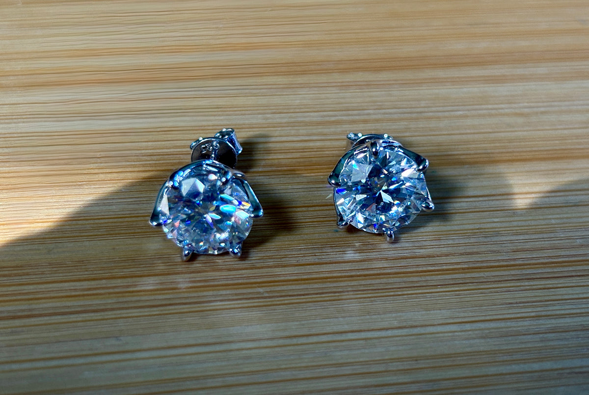 A 10ctw pair of double certified Moissanite studs in lotus-shaped sterling silver baskets!