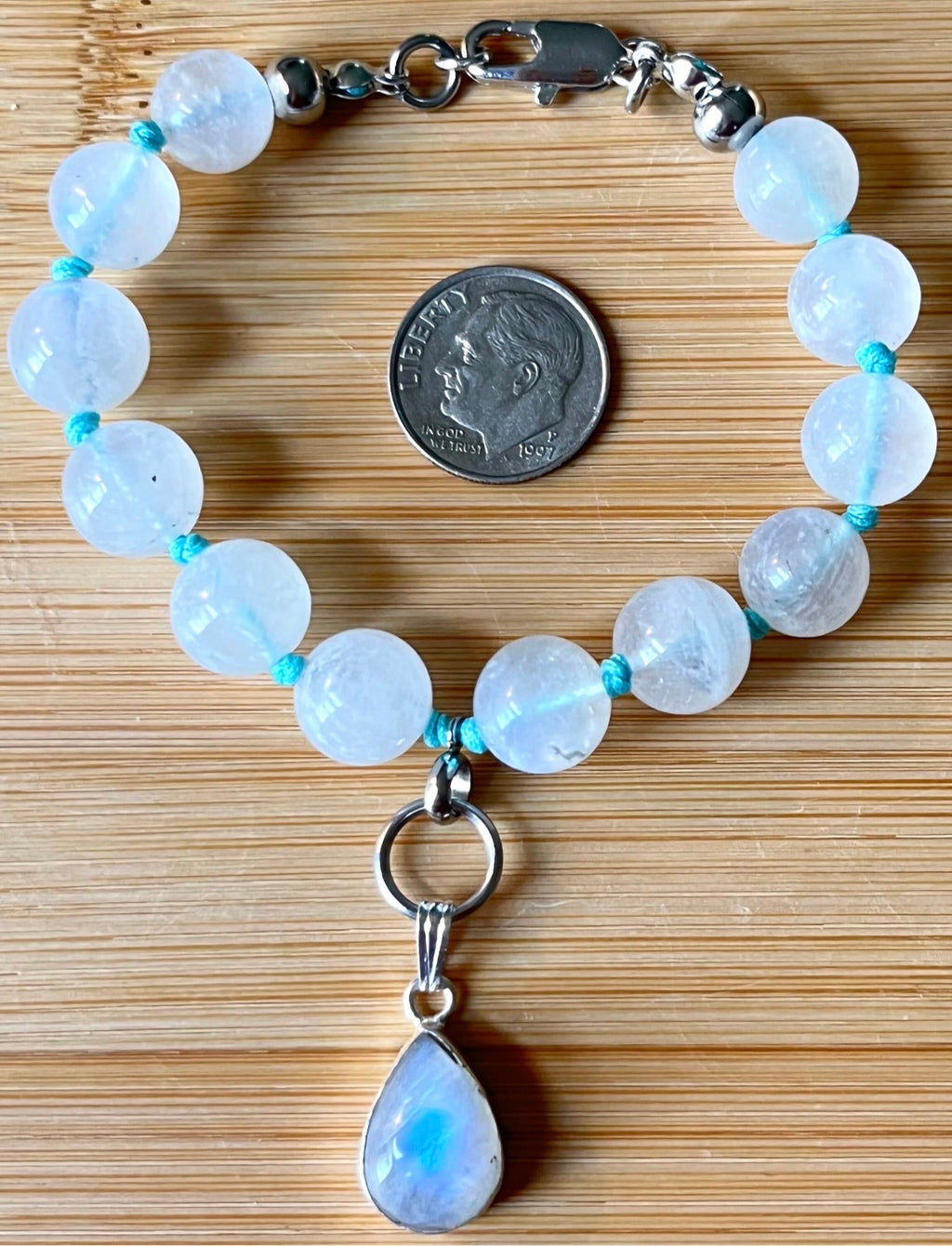 Rainbow moonstone bracelet, hand knotted with high quality 9-10mm beads! The solid sterling silver moonstone pendant is *optional*.