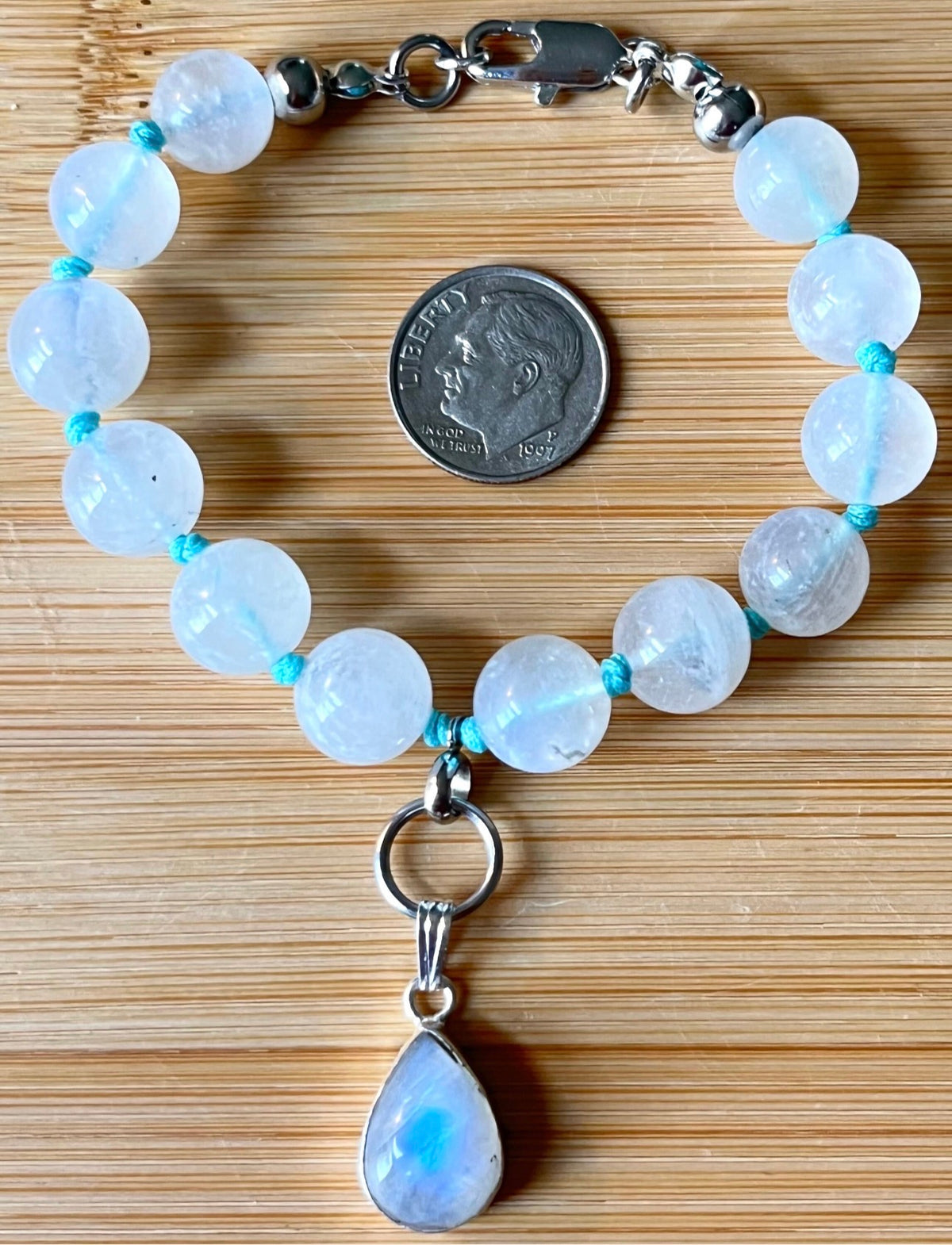 Rainbow moonstone bracelet, hand knotted with high quality 9-10mm beads! The solid sterling silver moonstone pendant is *optional*.