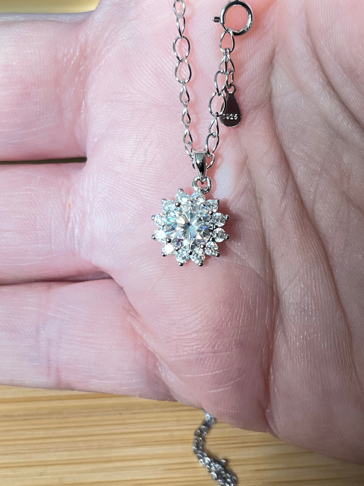 Moissanite necklace. A 1ct or 3ct Moissanite in a halo of sparkling white zircons (I call it the “Sunflower” pendant)! In sterling silver and 18k!