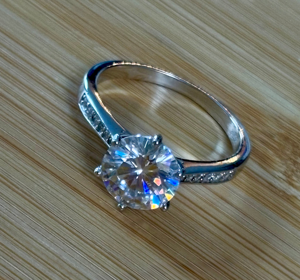Moissanite ring. A delicious 3ct certified Moissanite solitaire with tapered shoulders and pavé-set white zircons in sterling and 18k gold!