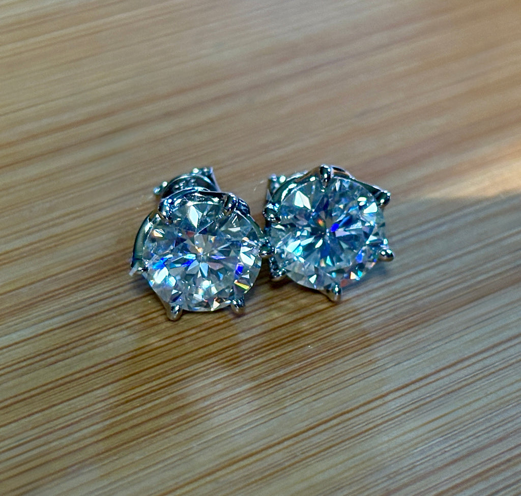 A 10ctw pair of double certified Moissanite studs in lotus-shaped sterling silver baskets!