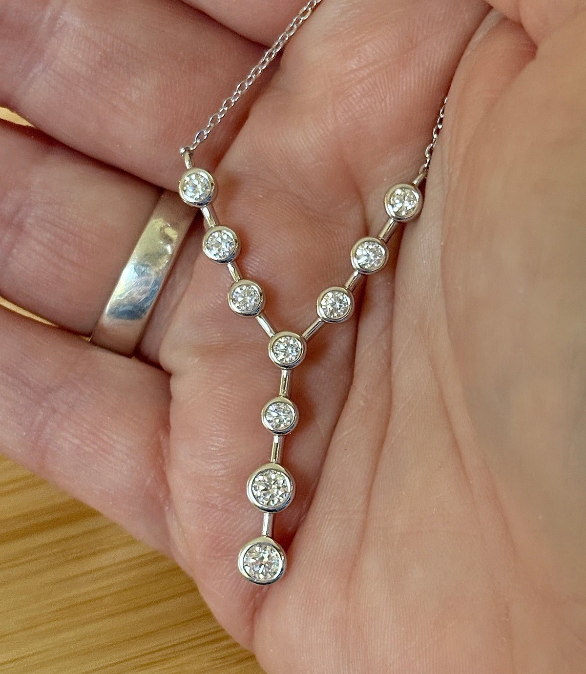 Moissanite neckpiece. A beautiful certified 1.4cttw Moissanite necklace featuring 10 round brilliants in a solid sterling bezel setting!