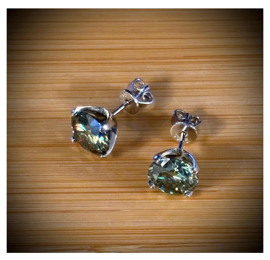 Moissanite studs. A 2cttw or 6cttw pair of cyan (greenish-blue) Moissanite studs. Double certified and rich in color, they are delicious!