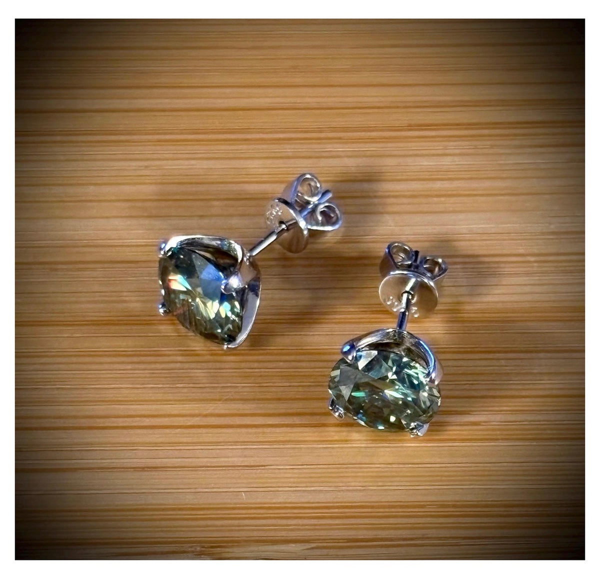Moissanite studs. A 2cttw or 6cttw pair of cyan (greenish-blue) Moissanite studs. Double certified and rich in color, they are delicious!