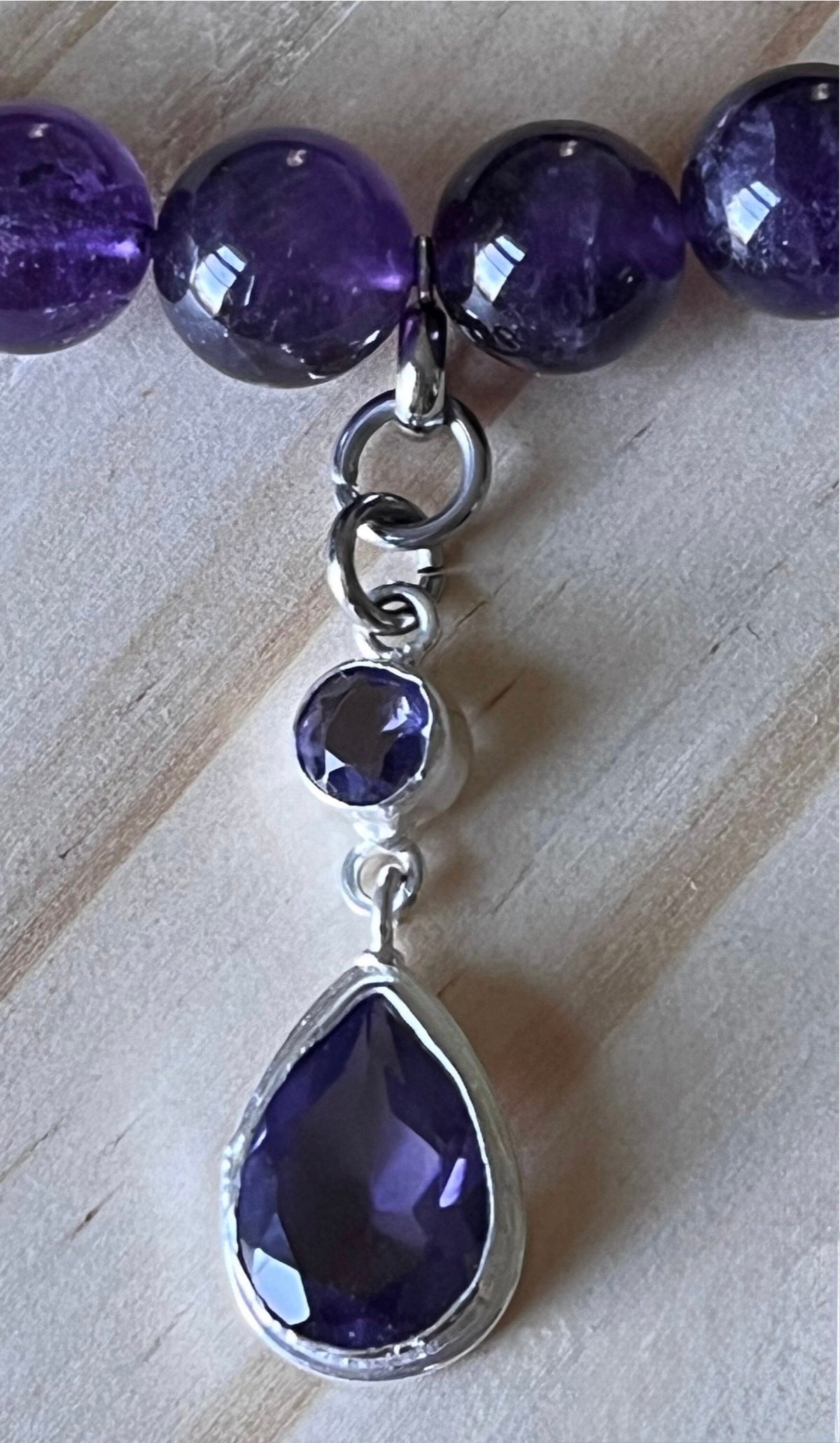 Amethyst bracelet. Natural and vibrant 10mm amethyst beads and stainless steel! The amethyst pendant in solid sterling silver is optional.