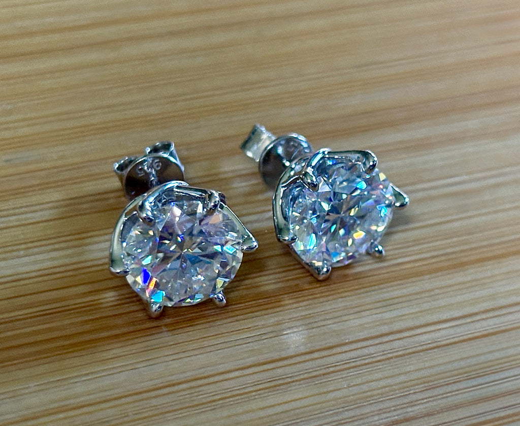 A 10ctw pair of double certified Moissanite studs in lotus-shaped sterling silver baskets!