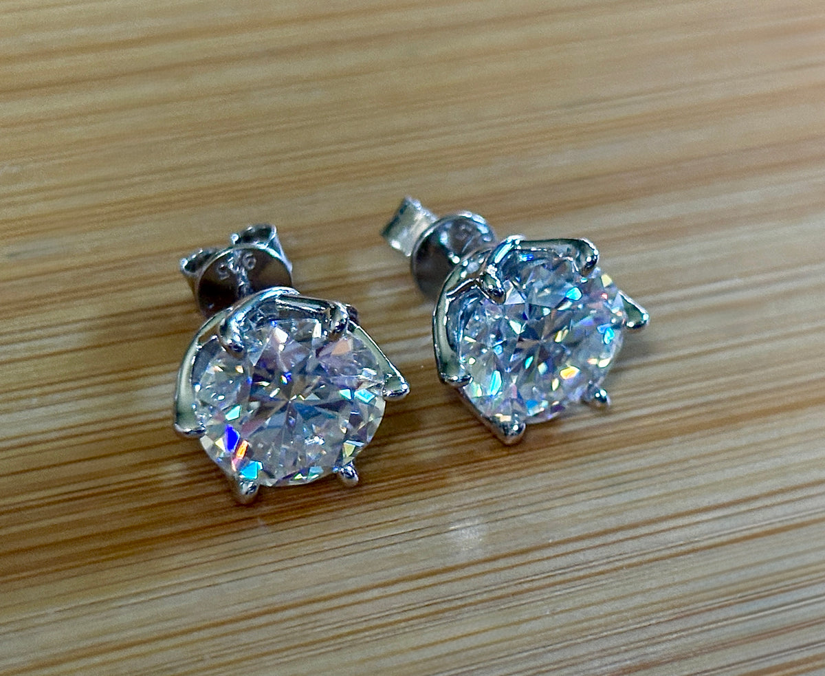 A 10ctw pair of double certified Moissanite studs in lotus-shaped sterling silver baskets!