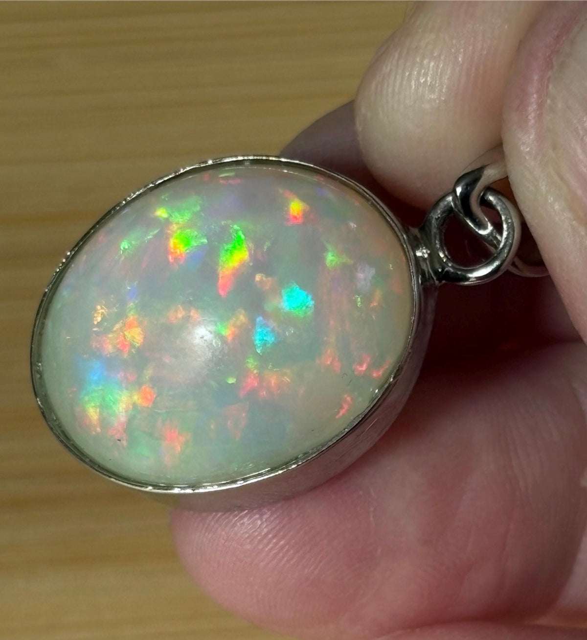 A 17.28ct AAA grade Ethiopian opal pendant with multi-patterned fire and beautiful play of color, hand-picked by Hand Knotted Jewelry!