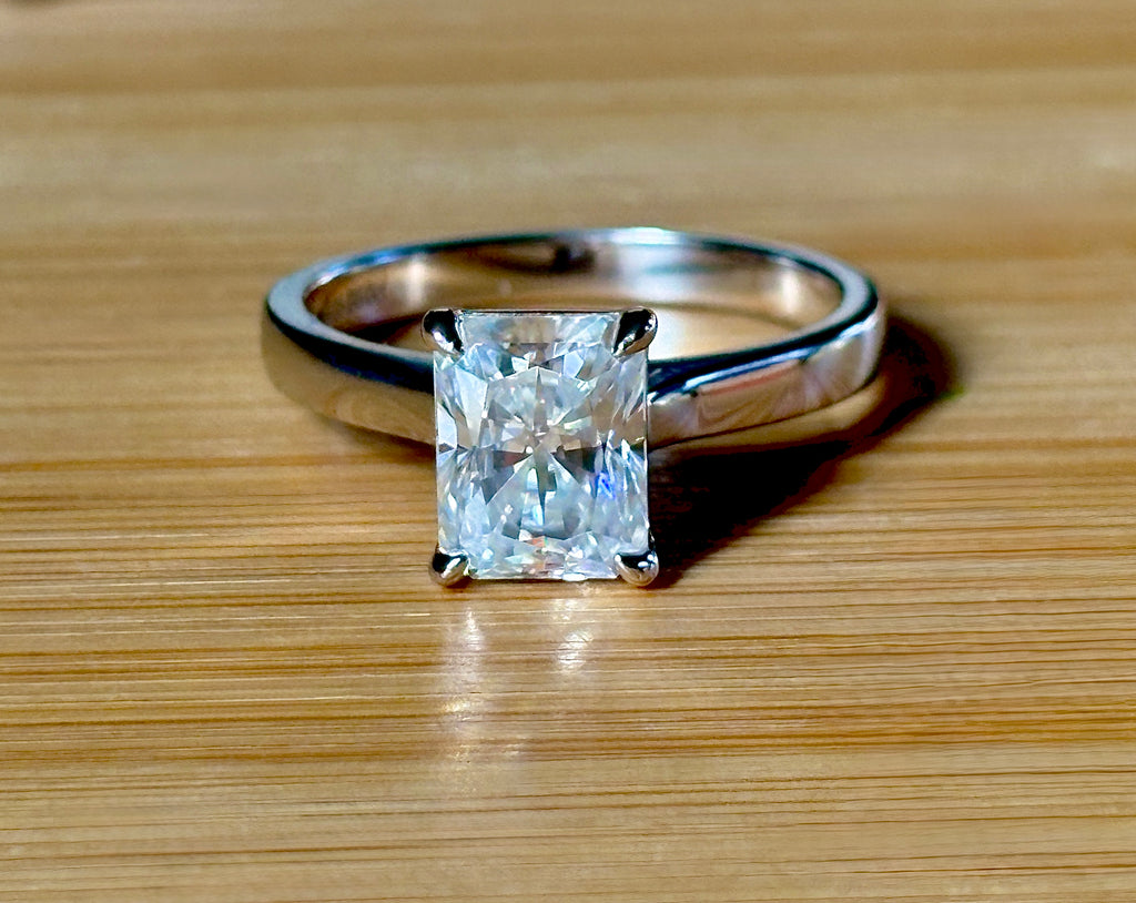 A certified Moissanite 3ct radiant solitaire! An UBER flashy, ULTRA classy, contemporary and chic radiant-cut engagement ring!