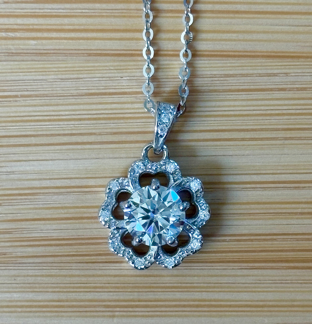 Moissanite necklace. A certified 1ct Moissanite hibiscus necklace with white zircon accents in solid sterling and white rhodium!
